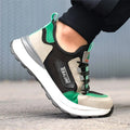 Black and green low-top lightweight mesh plastic steel toe safety shoes on white background