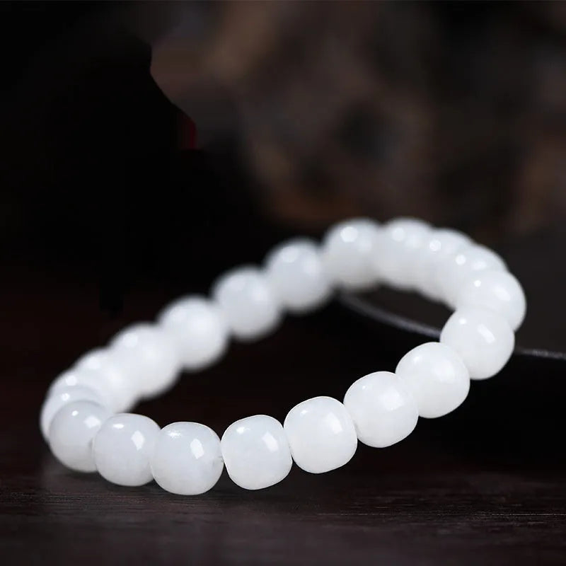 White Hetian jade barrel bead bracelet on a wrist, showing three bead size options for men and women.