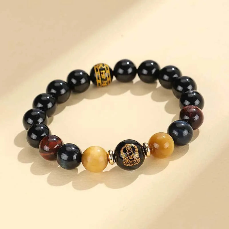 Black agate beaded bracelet with tiger eye stones in ethnic style on plain background