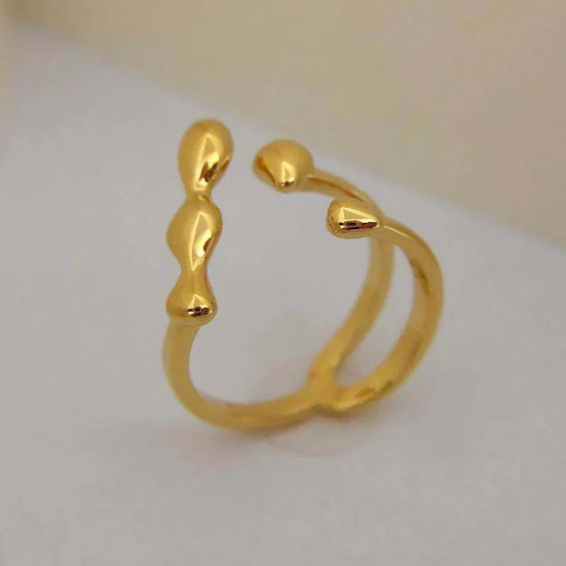 Gold brass opening ring with spherical decorative element on circular band