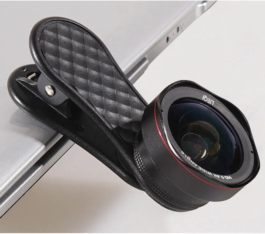 Black LQ-046 smartphone wide-angle and macro lens kit with clip and storage case on a table.