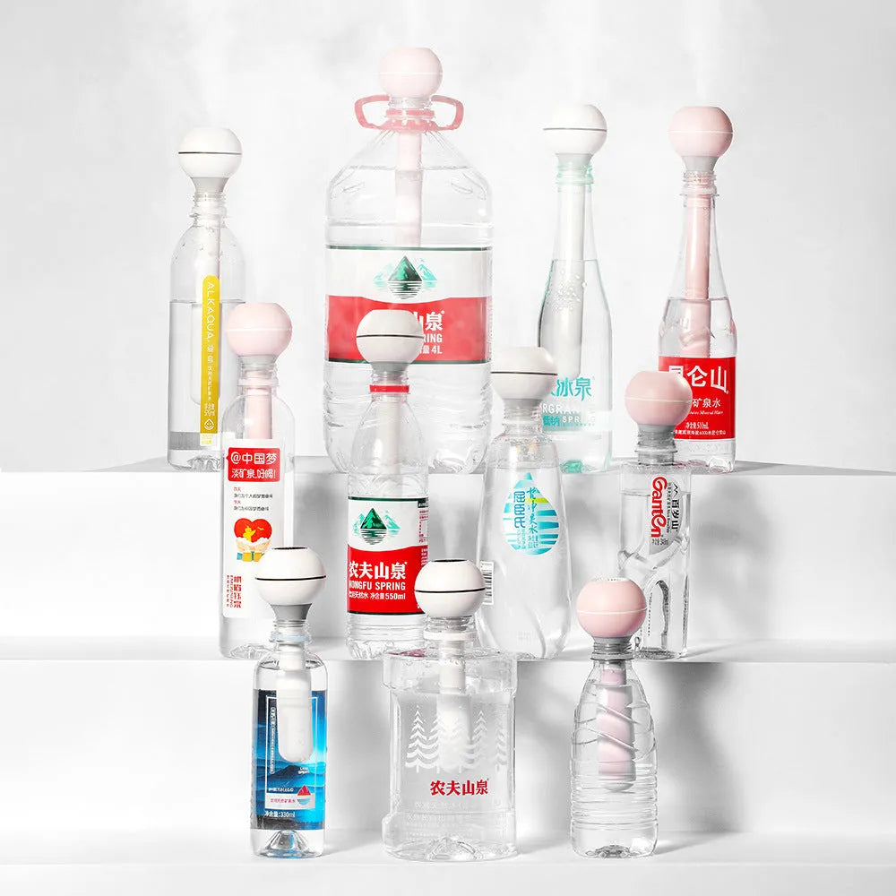 Columnar magic wand humidifier in pink or white with USB port and mechanical controls.