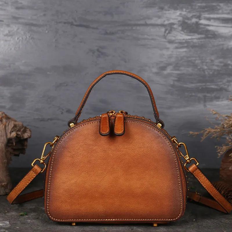 Vintage leather handbag showing interior compartments including ID holder and phone pouch