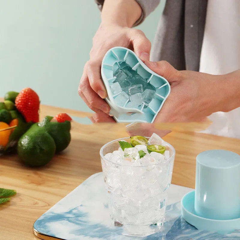 Portable 2-in-1 silicone ice bucket mold with lid in blue-green on a white background