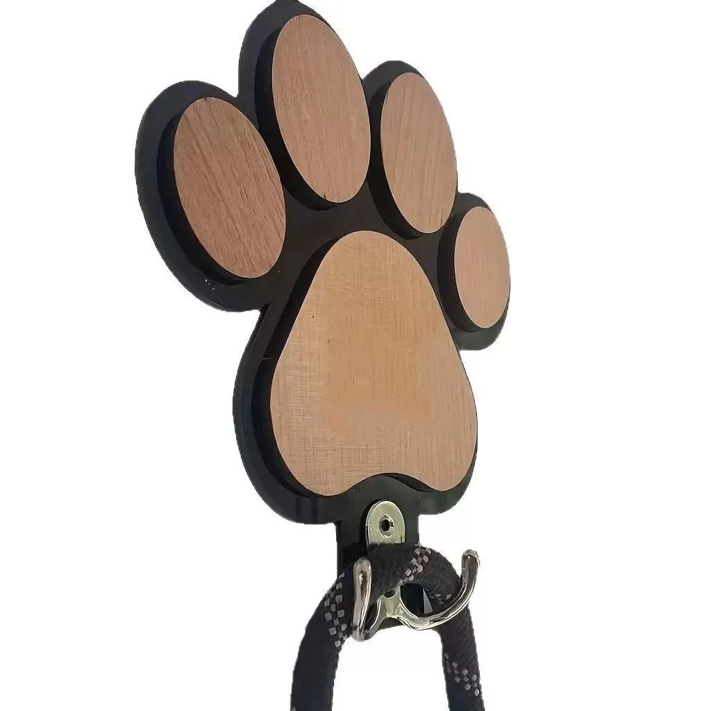 Wooden foot paw print wall hook in black finish, modern simplicity style, with a coat hanging from it