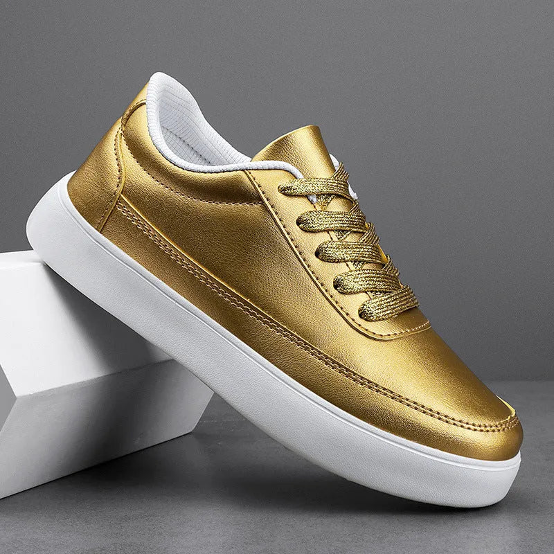 Women's leather flat casual trainers in gold, featuring front lace-up design on a white background.