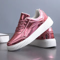 Gold sequined platform sneakers with round toe and thick MD sole on a white background.