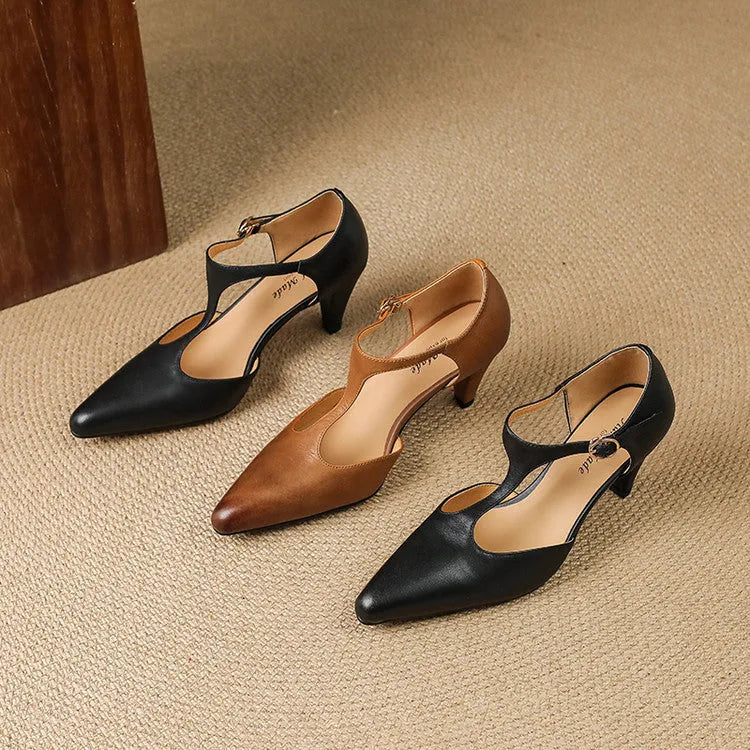 Women's brown retro T-bar strap sandals with a closed round toe and a chunky leather heel.