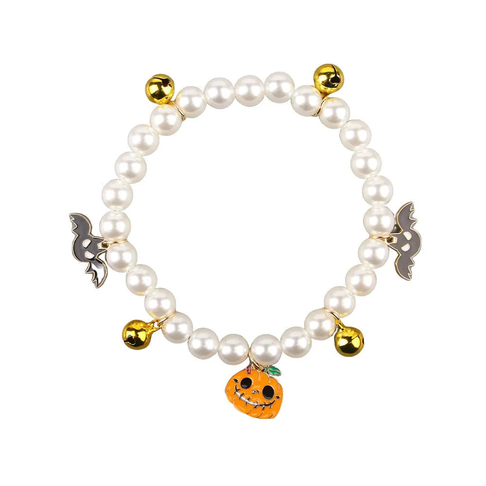Halloween decorative cat collar with simulated pearl necklace in purple ghost pumpkin, skull pumpkin, and smiling pumpkin patterns.
