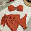 Brown floral three-piece swimsuit set with tube top, pants, and skirt on a model
