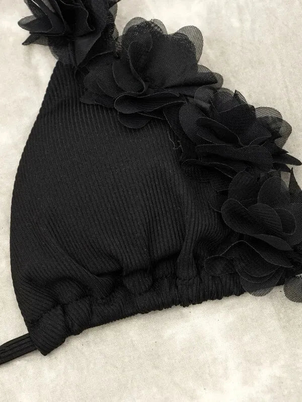 Black gathered polyester two-piece women's swimwear set with top and shorts on a model