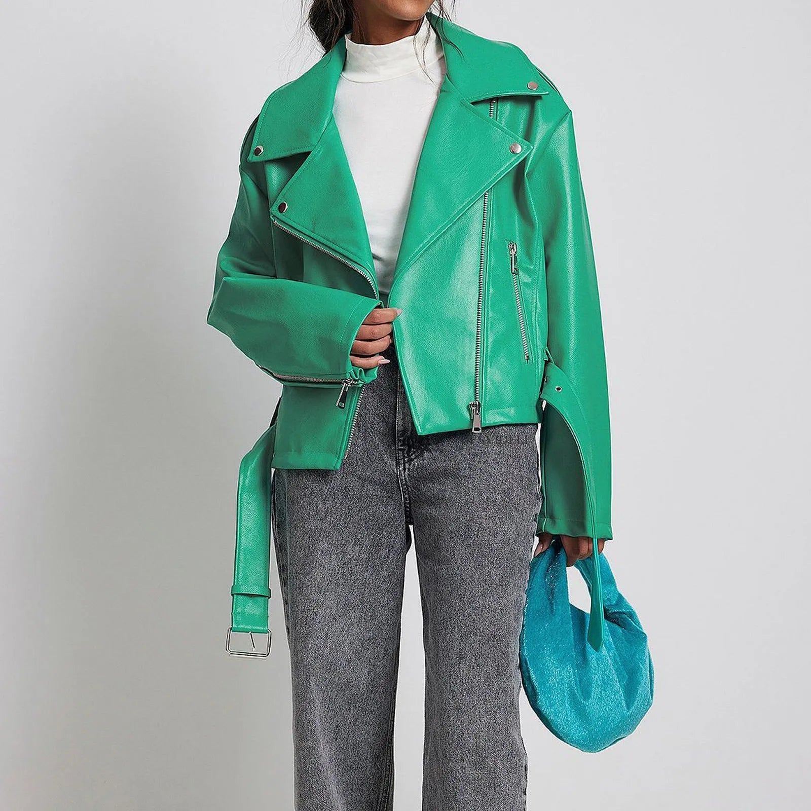 Black punk style leather jacket with a Peter Pan collar and drawstring waist on a hanger.