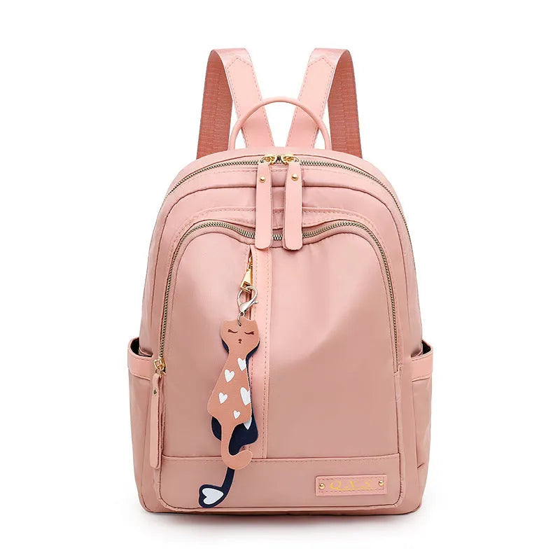 Women's black nylon casual backpack with double shoulder straps, soft handle, and front pocket.