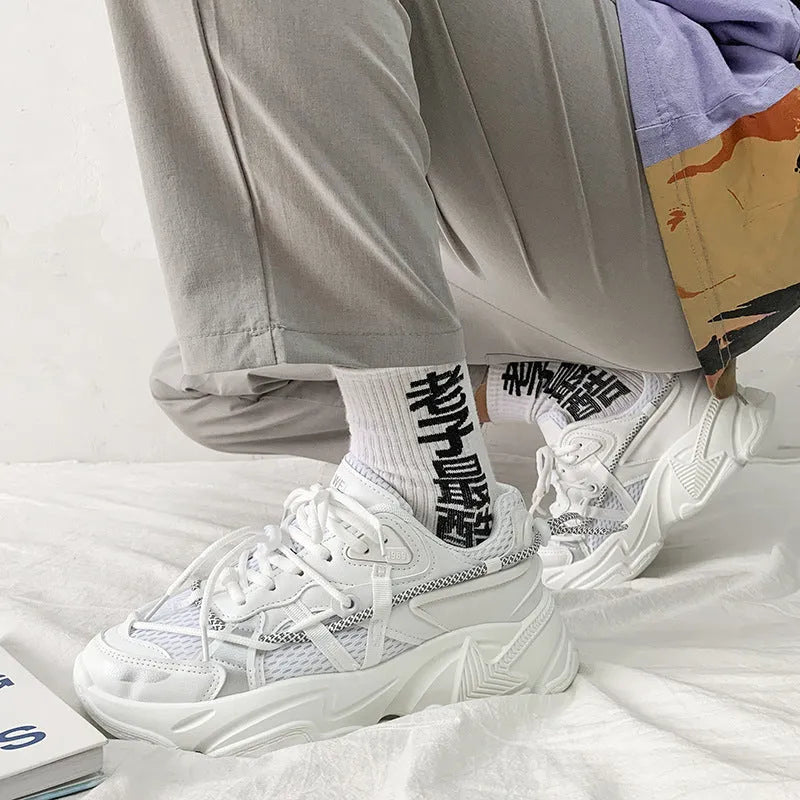 Men's white, black, and grey platform dad shoes with thick soles and lace-up front.