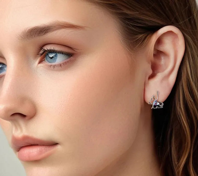 925 silver butterfly stud earrings with moonstone inlay on a white background