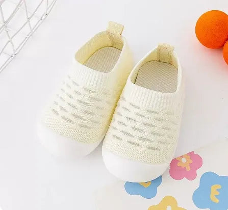 Baby soft sole non-slip walking shoes in cream yellow with fly woven cotton upper and natural rubber sole