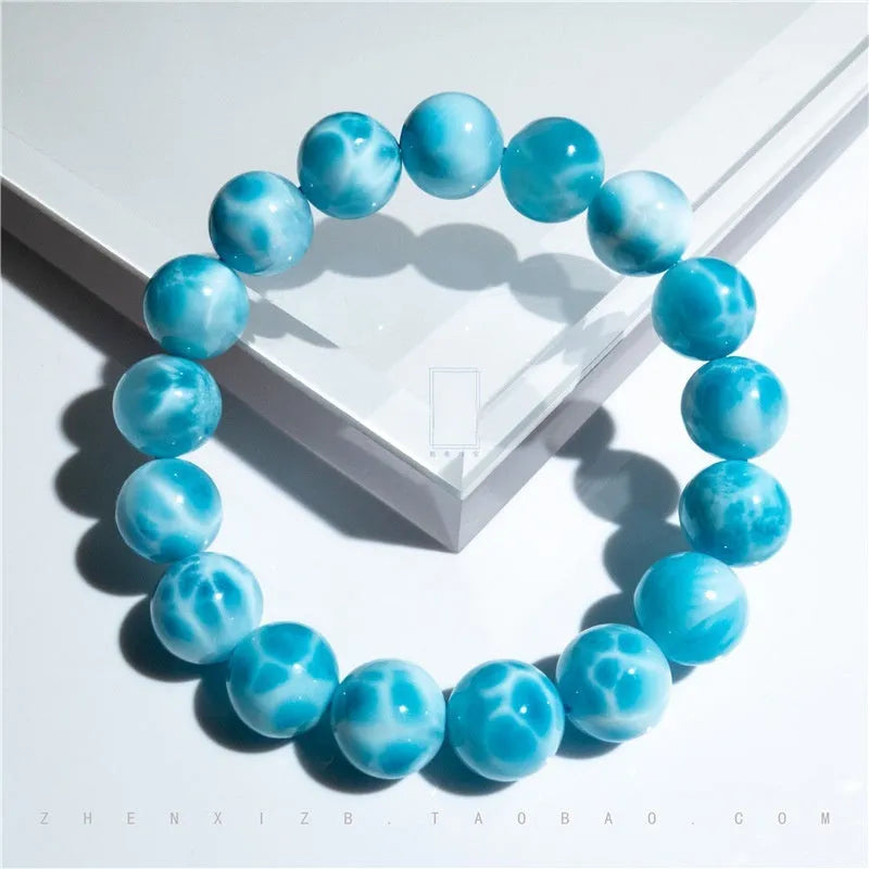 Blue handmade Bodhi bracelet with sea-pattern crystal stone and pearl accent in Maillard style.