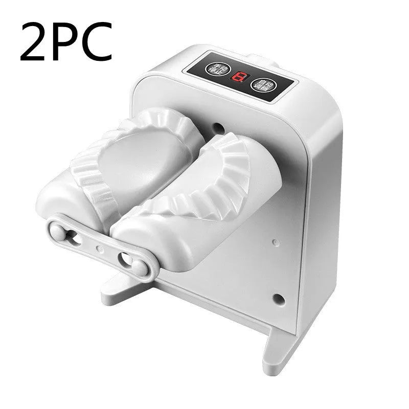 White automatic electric dumpling maker machine on a kitchen counter with USB cable and accessories