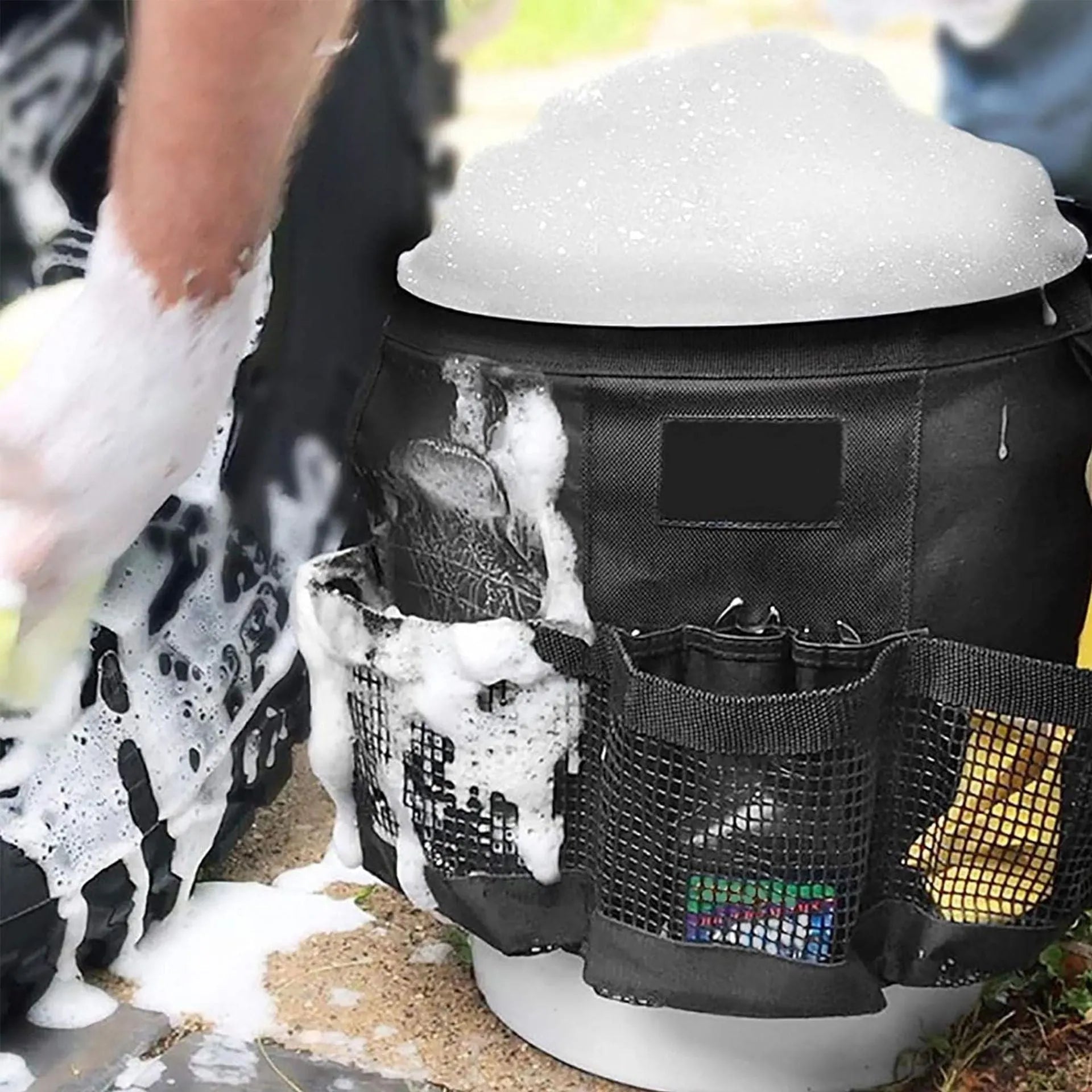Black cylindrical polyester storage bag hanging on 5 gallon barrel with tools organised inside