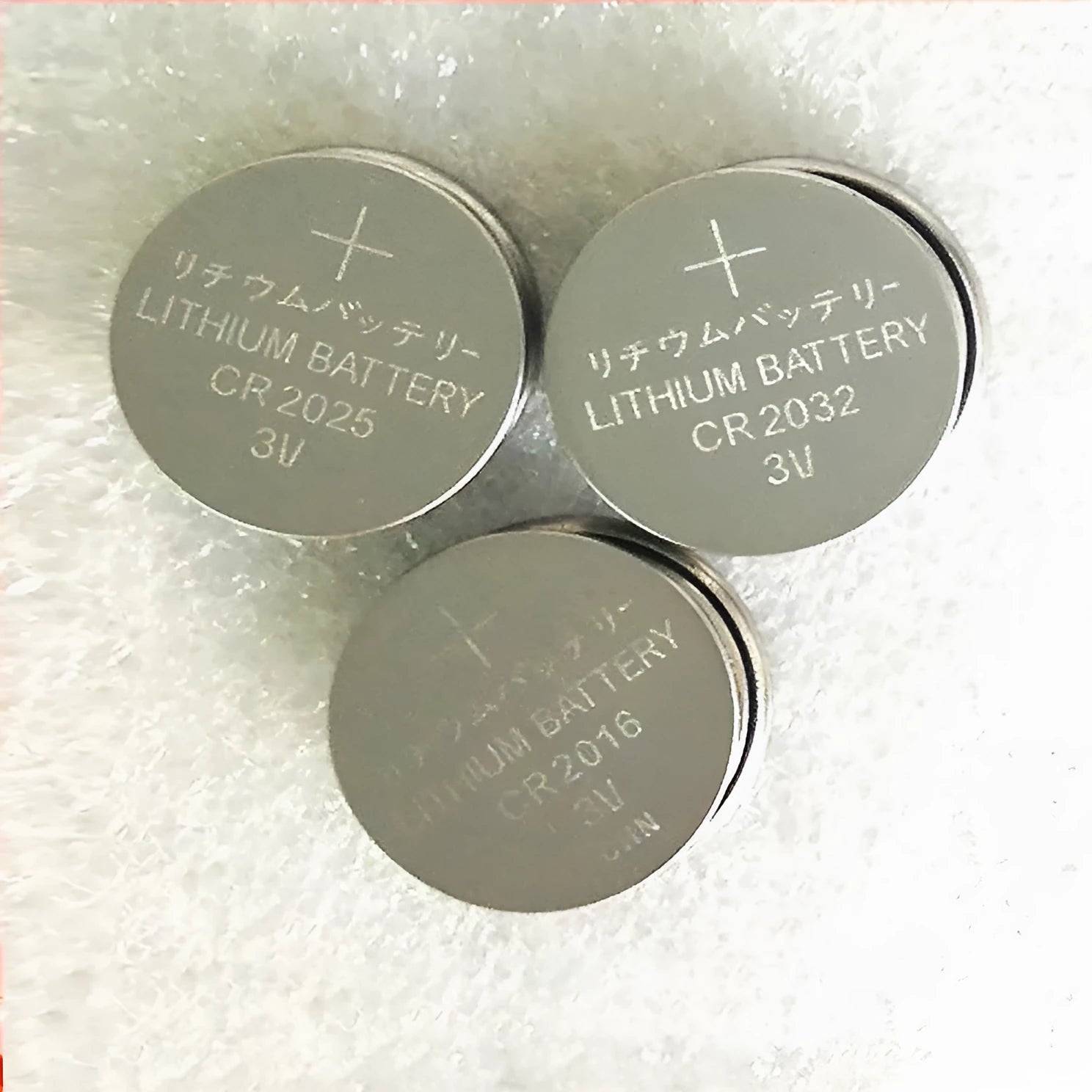 3V button battery CR2032 alkaline cell 20mm diameter on white background