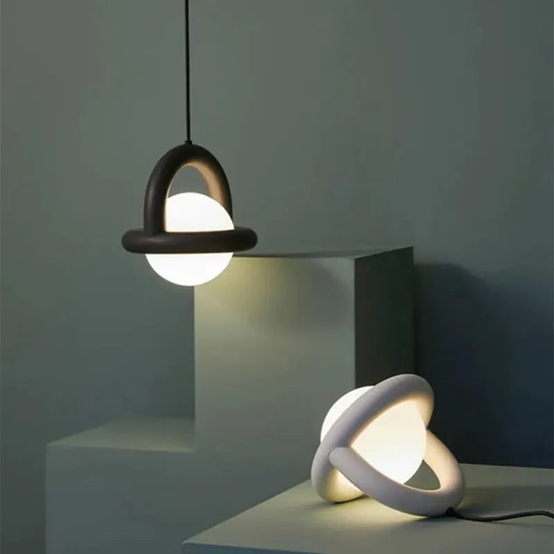 Modern Danish designer pendant lamp with adjustable cord in matte finish hanging above bedside