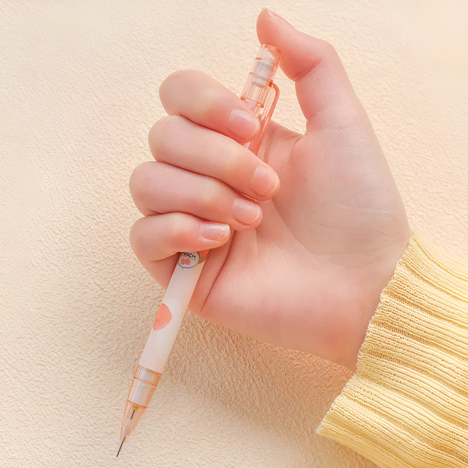 Automatic pencil press 0.5 no sharpening in peach colour with plastic casing and 100 refills