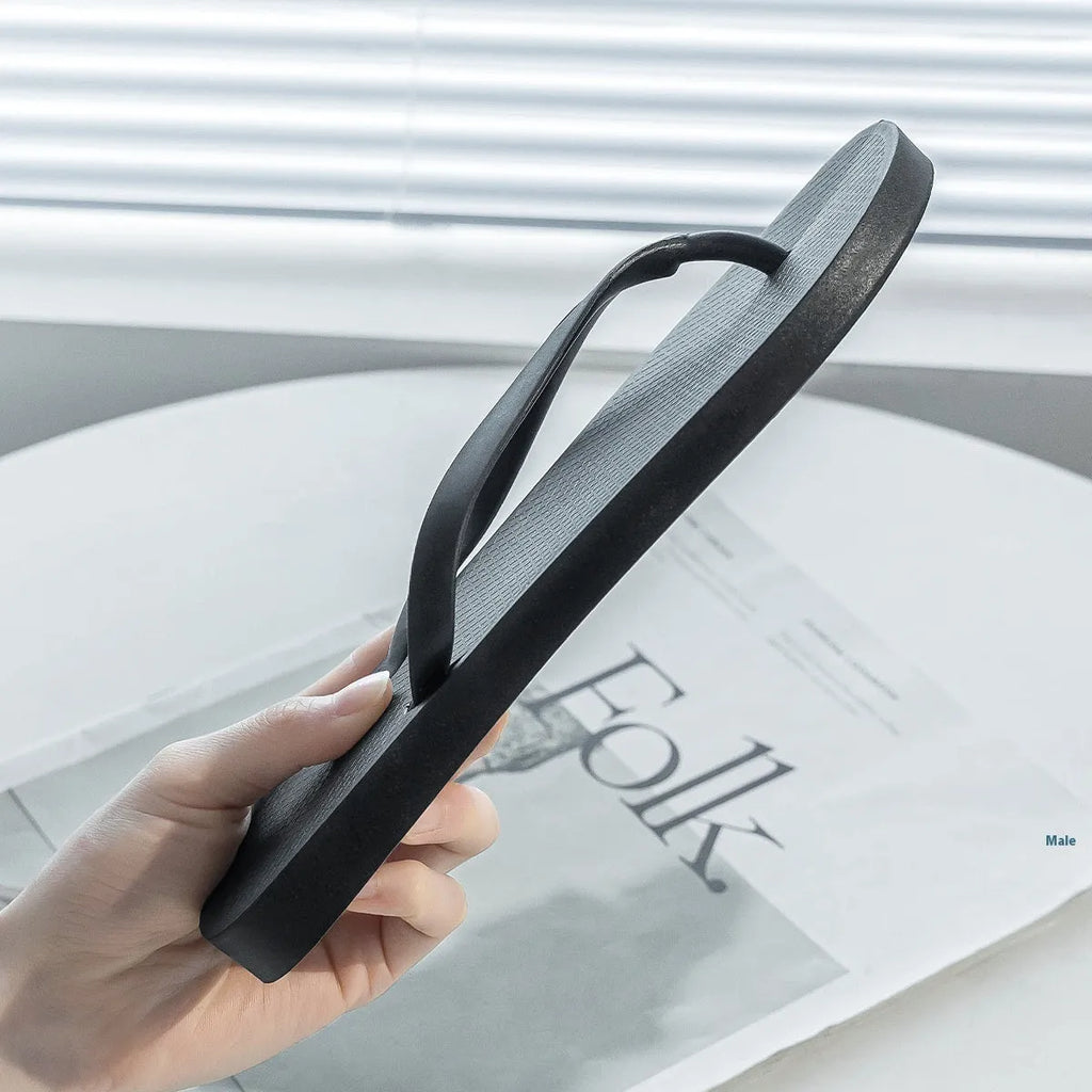 Foldable plastic beach slippers with non-slip sole in black, shown open and folded.