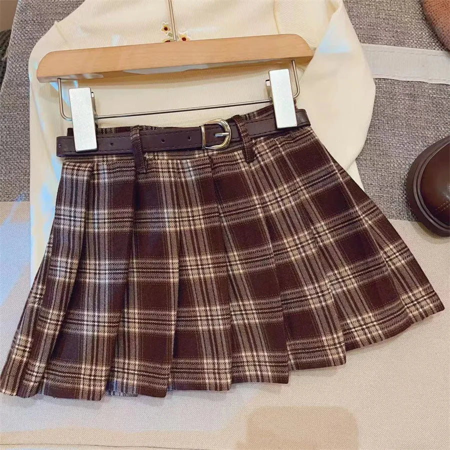 Girls red and black plaid pleated A-line skirt made from cotton blend fabric.