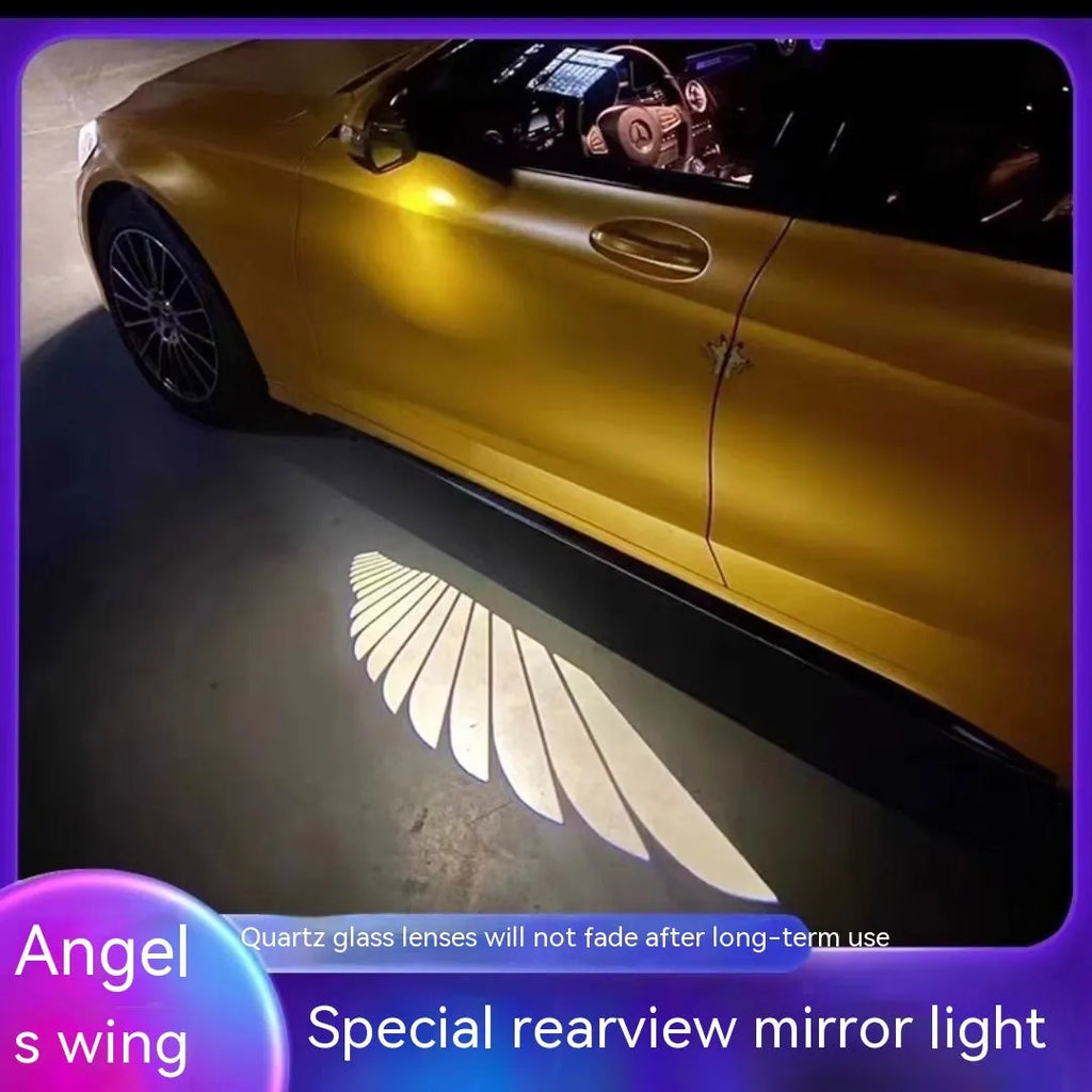 Car rearview mirror courtesy lamp projecting white angel wings light onto ground near vehicle door