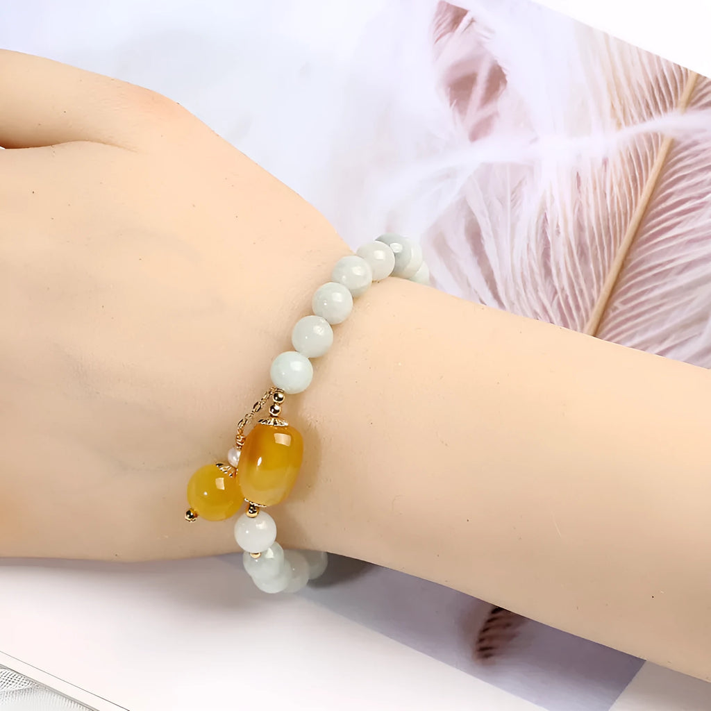 Women's bracelet with red agate round beads 7.5mm and hanging tassel in 14K gilded finish