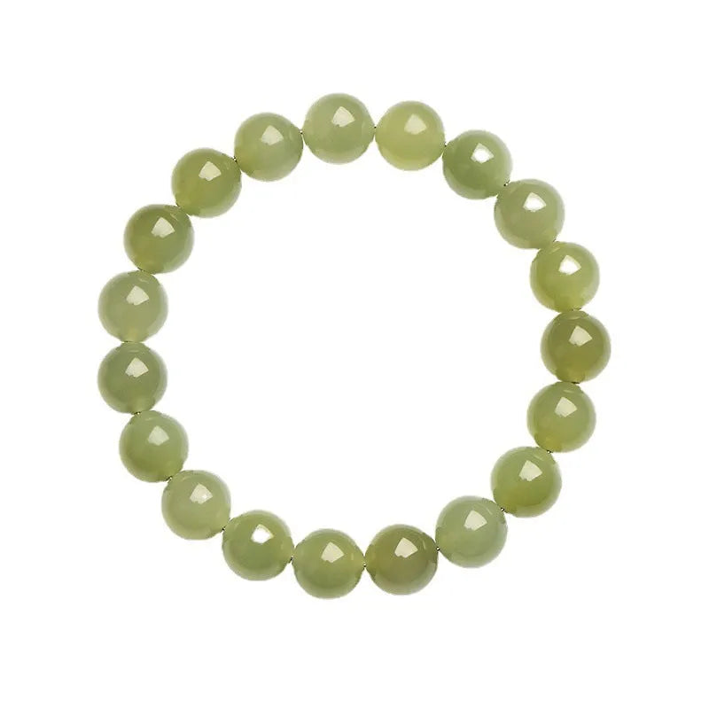 Polished Hetian jade bead bracelet in ice-clear colours on a wrist, showing spherical beads.