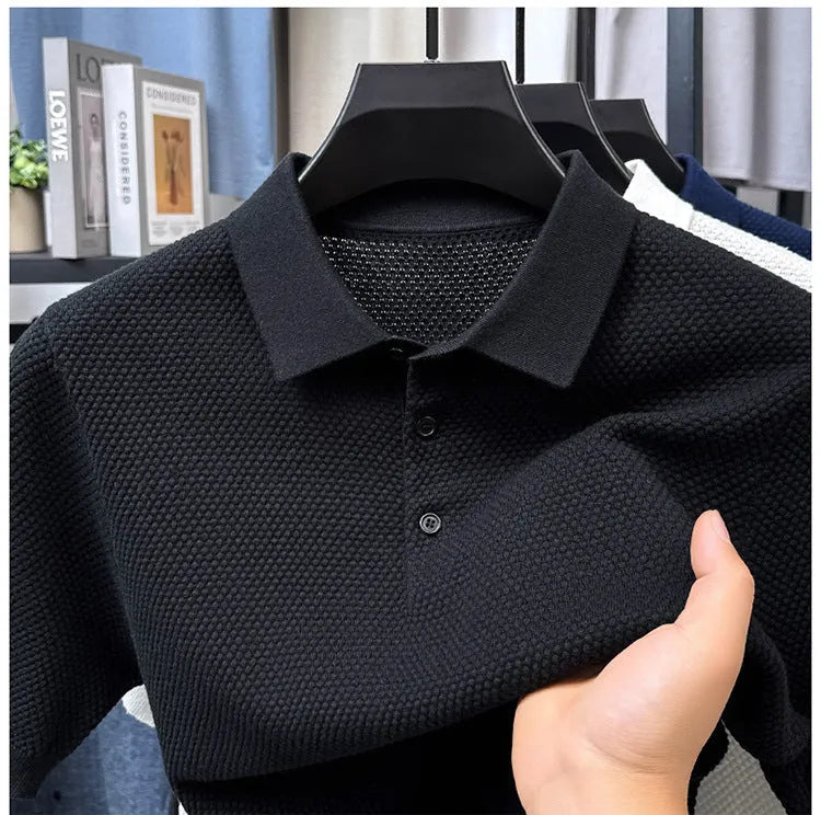 A loose short-sleeved cotton pullover sweater on a hanger, shown in a solid colour.