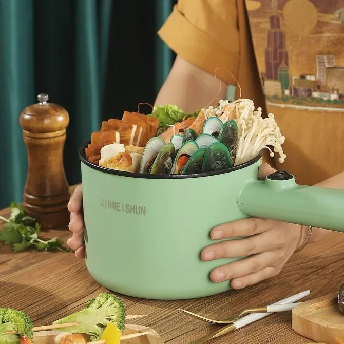 Mini hot pot electric cooker in green with stainless steel body, non-stick pot, and steam grid option for portable cooking