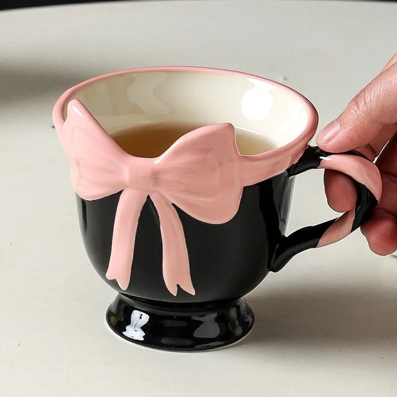 Ceramic mug with heart bow design in white powder or black pink colours, 301-400ml capacity