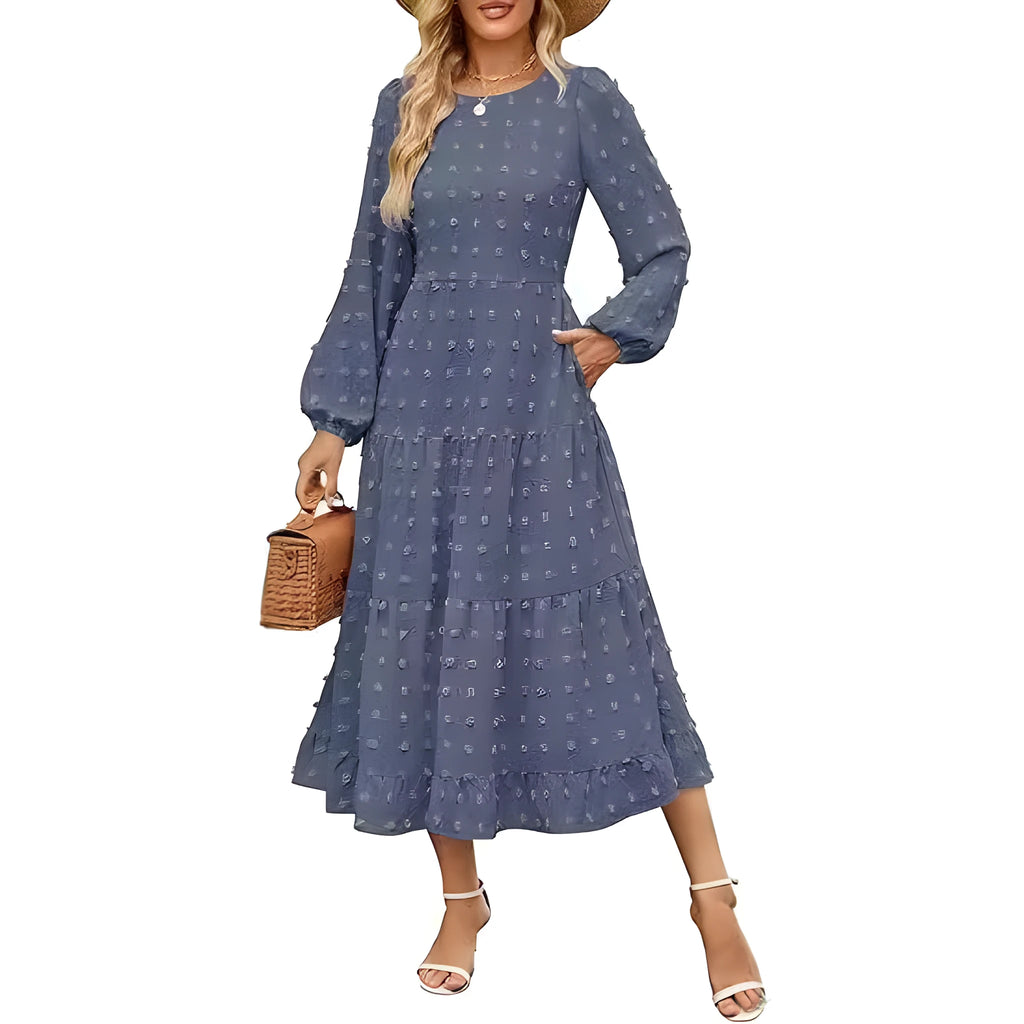 A woman wearing a beige high waist long sleeve dress with ruffle details on a autumn day.