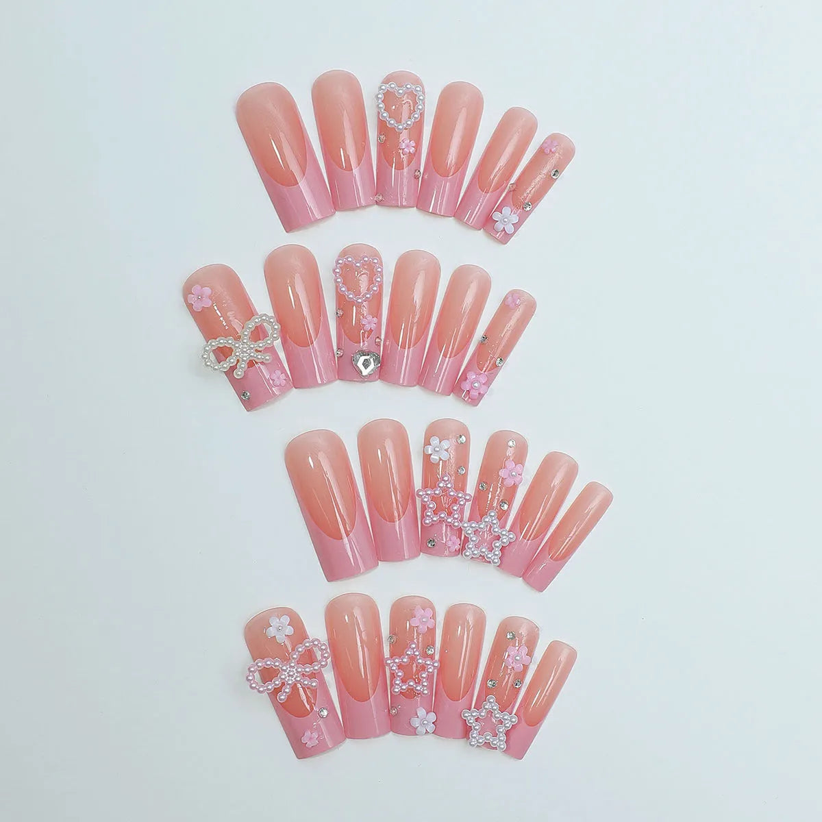 Super long false nails with a red love pattern, spot drill details, and a bow accent on a plastic armour suit.