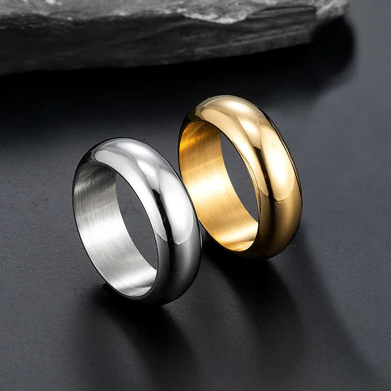 Glossy electroplated titanium steel ring in gold colour on a white background.