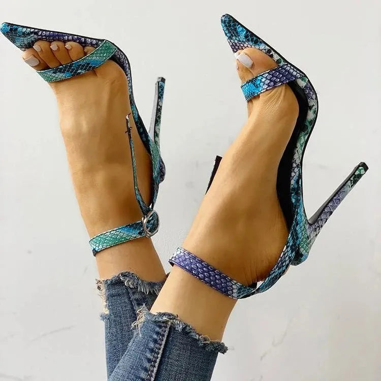 Blue women's high heels with hollow-out detail and buckle strap, pointed toe, European serpentine style.