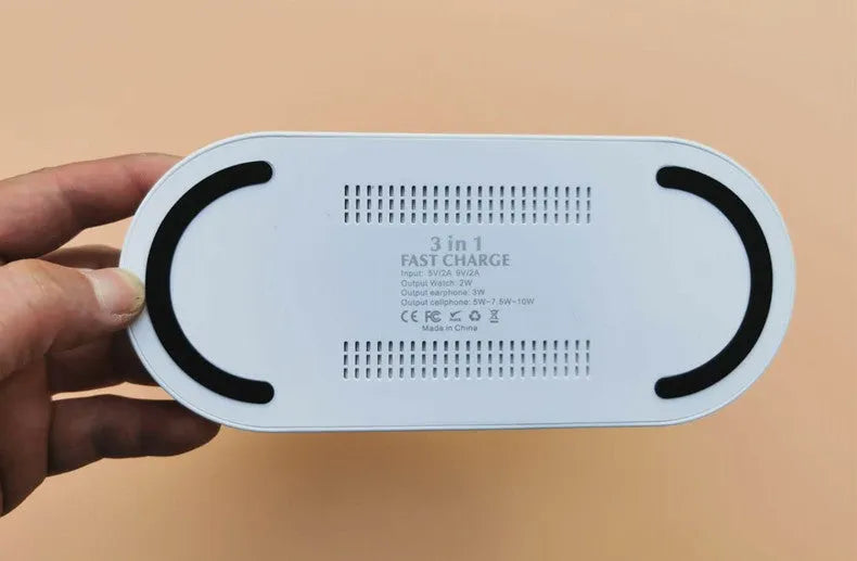 Black three-in-one wireless charger station with phone pad and watch output on a desk, 10W fast charging