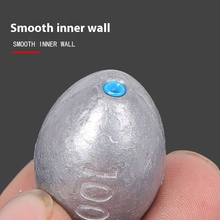 Olive-shaped sea fishing lead sinker with scale pattern texture and plastic core