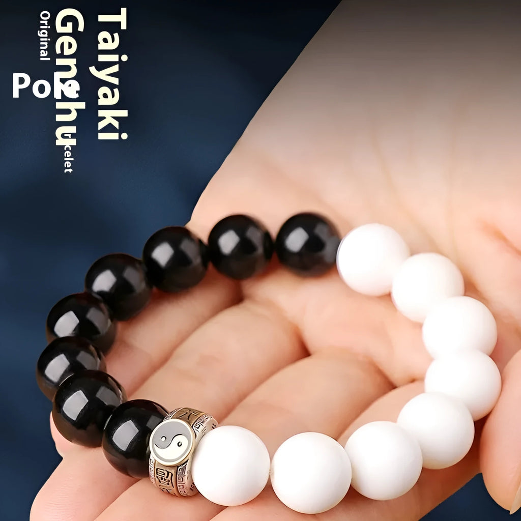 Black and white obsidian geometry-shaped bead bracelet on neutral background