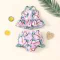 White two-piece toddler swimsuit set with a top and matching shorts on a hanger.