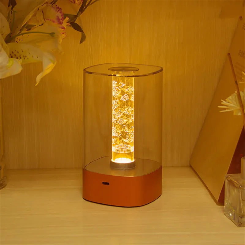 Rose gold LED touch atmosphere light with Auspicious Cloud pattern on a bedside table, USB charging cable included