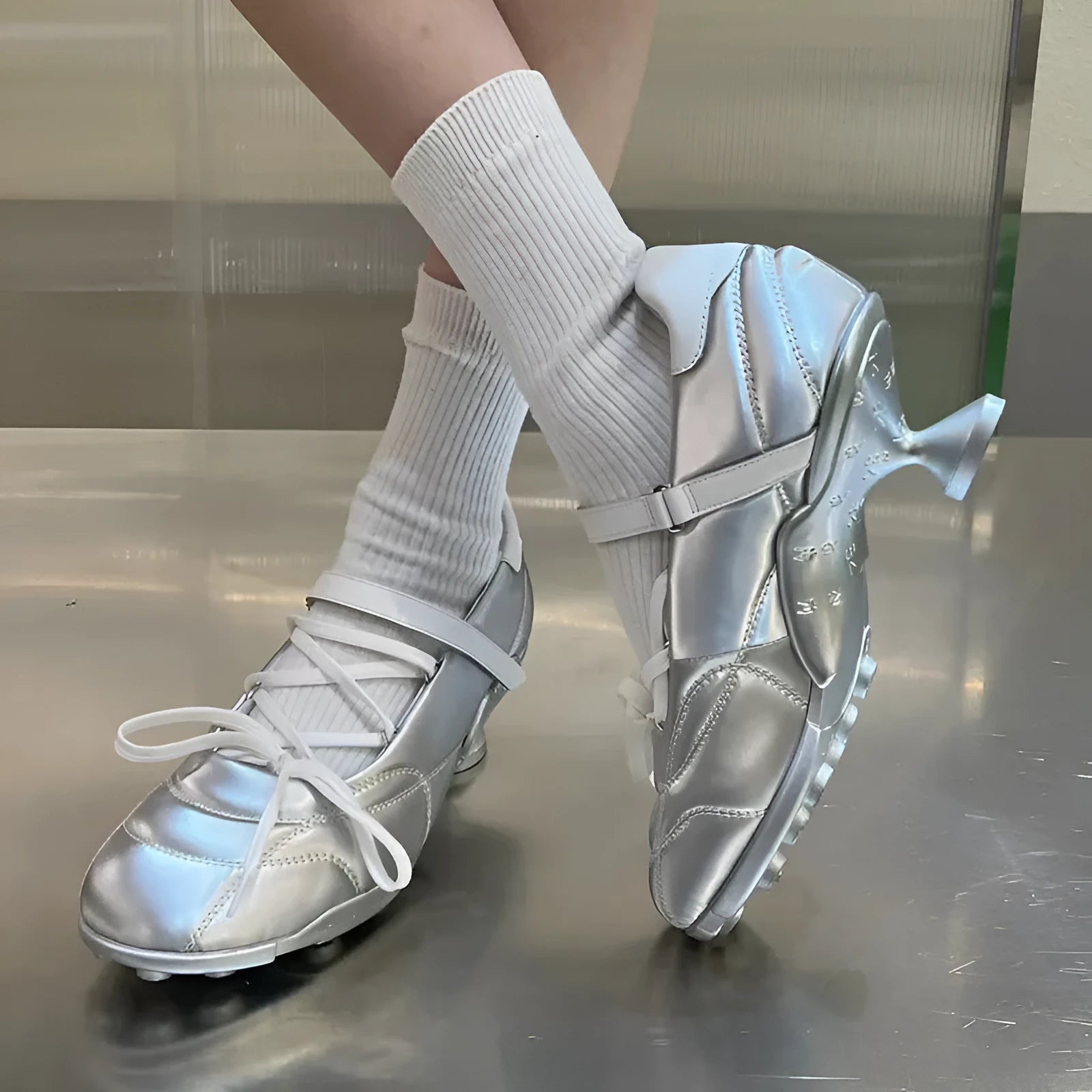 Women's silver lace-up sports shoes with a bow on the front, round toe, and leather stitching details on the microfiber upper.