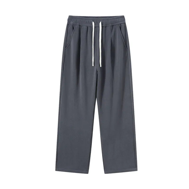 Men's apricot double-sided polar fleece winter trousers with a loose fit and drawstring waistband on a hanger.