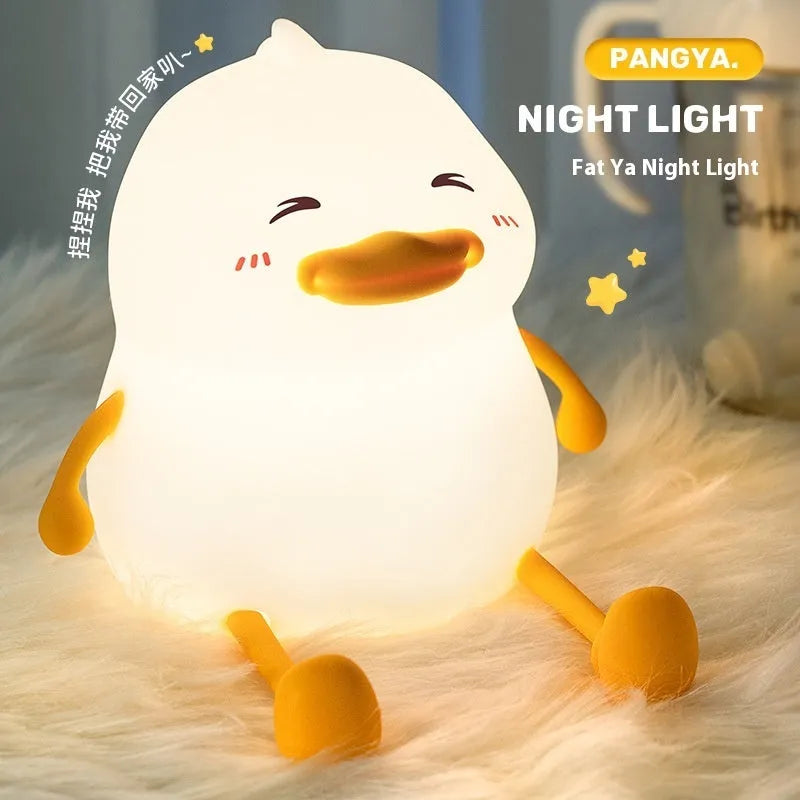 Chubby silicone night lamp on a desk showing phone holder and soft LED glow.