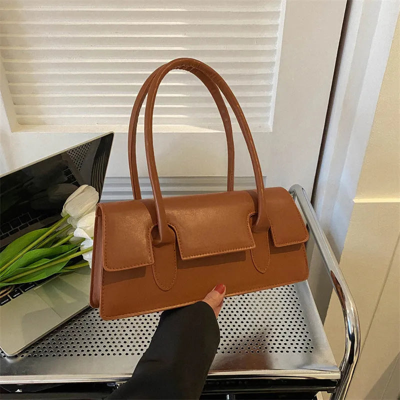 Women's retro style small square PU shoulder bag in black with visible stitching and a single strap