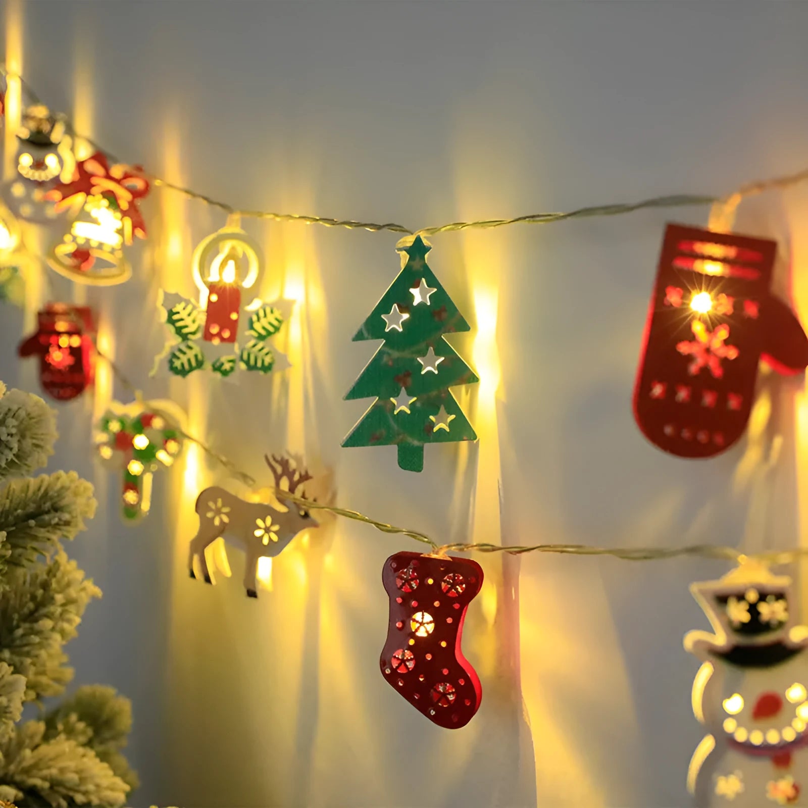 Christmas LED light string with Santa Claus, elk, and snowman ornaments on a dark background