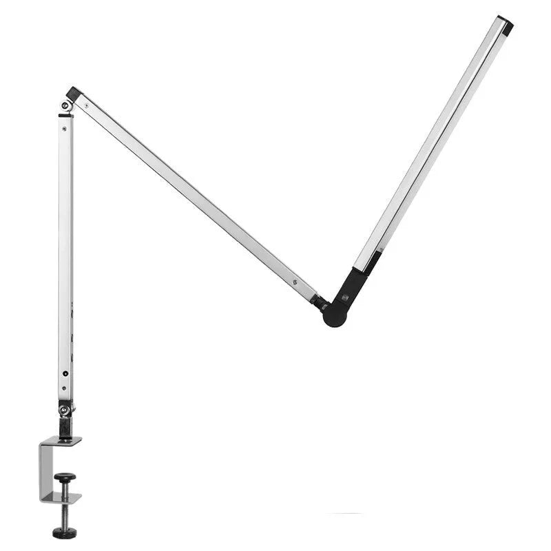 Black clip-on LED desk lamp with remote control attached to a desk edge, showing its folding arm.