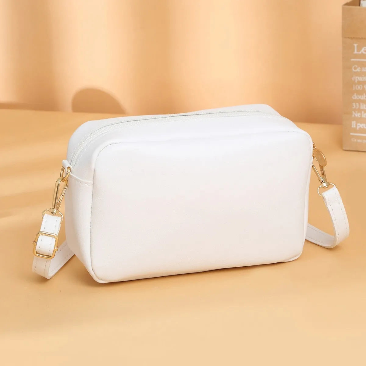 Women's square shoulder bag in PU material with a 3D front pocket, shown in a solid colour.